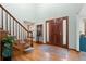 Inviting foyer with hardwood floors, staircase, and natural light enhancing the warm and welcoming atmosphere at 16234 E Belleview Dr, Centennial, CO 80015