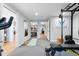 Basement gym featuring weight training equipment, mats and mirrors at 16234 E Belleview Dr, Centennial, CO 80015