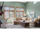Bright living room with a fireplace and large windows providing natural light at 16234 E Belleview Dr, Centennial, CO 80015