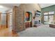 Open-concept living room with a brick fireplace, bar area, and access to a bathroom at 16234 E Belleview Dr, Centennial, CO 80015