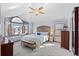 Comfortable bedroom with natural light, a bench, and a ceiling fan at 16234 E Belleview Dr, Centennial, CO 80015