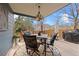 Covered patio featuring a dining table with 4 stools, an outdoor ceiling fan and an outdoor grill at 16234 E Belleview Dr, Centennial, CO 80015