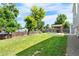 Expansive backyard with mature trees, green lawn and covered patio at 6604 S Dahlia Cir, Centennial, CO 80121