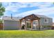 View of backyard featuring a covered patio with wood supports at 6604 S Dahlia Cir, Centennial, CO 80121