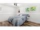 Bright room features a queen size bed with stylish gray and white decor and natural light at 6604 S Dahlia Cir, Centennial, CO 80121