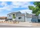 Charming two-story home featuring stylish blue siding and an attached garage at 6604 S Dahlia Cir, Centennial, CO 80121