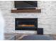 Modern fireplace with a stone surround and a wooden mantel at 6604 S Dahlia Cir, Centennial, CO 80121