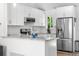 Modern kitchen with white cabinets, stainless steel appliances, and granite countertops at 6604 S Dahlia Cir, Centennial, CO 80121