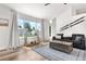 Sunlit living room with large windows, vaulted ceiling, and hardwood floors at 6604 S Dahlia Cir, Centennial, CO 80121