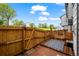 Private backyard patio area with wood fence, deck, rock garden, and distant view at 2002 E 102Nd Cir, Thornton, CO 80229