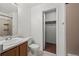 Hall bathroom features a vanity, framed mirror, toilet, and tiled shower at 2002 E 102Nd Cir, Thornton, CO 80229