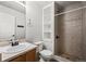 Bathroom with a walk-in shower, toilet, vanity and custom storage shelving at 2002 E 102Nd Cir, Thornton, CO 80229