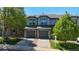 Charming townhome with stone accents, gray siding, and attached garages at 2002 E 102Nd Cir, Thornton, CO 80229