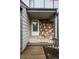 Inviting covered front entry with stone accents and neutral siding at 2002 E 102Nd Cir, Thornton, CO 80229