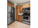 Modern kitchen with stainless steel appliances and sleek tile backsplash at 2002 E 102Nd Cir, Thornton, CO 80229