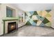 Cozy living room with a charming fireplace, large window providing natural light, and a colorful geometric accent wall at 2002 E 102Nd Cir, Thornton, CO 80229