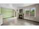 Open living room with a fireplace, large window, and tile flooring at 2002 E 102Nd Cir, Thornton, CO 80229