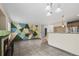 Open-concept living room with modern fireplace and brightly painted geometric wall design at 2002 E 102Nd Cir, Thornton, CO 80229