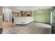 Open living space with tile flooring connecting to the kitchen and dining area at 2002 E 102Nd Cir, Thornton, CO 80229
