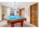 Fun game room with a blue pool table, wood floors, and a window at 11052 Rowland, Littleton, CO 80127