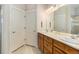 Bright bathroom features dual sinks, a large mirror, and clean, modern fixtures throughout at 1153 Village Cir, Erie, CO 80516