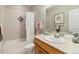 Cozy bathroom features a shower-tub combo, neutral tones, and tasteful decor at 1153 Village Cir, Erie, CO 80516