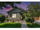 Lovely single-Gathering home with a manicured lawn, stone accents, and a covered entryway at 1153 Village Cir, Erie, CO 80516