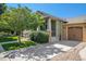 Craftsman home boasts a covered porch, attached garage, and mature shade tree in the landscaped front yard at 1153 Village Cir, Erie, CO 80516