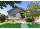 Charming single-story home with a well-manicured lawn, stone accents, and a welcoming entrance at 1153 Village Cir, Erie, CO 80516