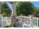 Charming front porch with seating for two, stone supports, and a cheerful potted plant on the table at 1153 Village Cir, Erie, CO 80516