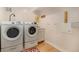 Functional laundry room with modern appliances, ample counter space, and efficient layout at 1153 Village Cir, Erie, CO 80516