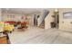 Expansive living area with mixed flooring and comfortable seating arrangement and easy access to the stairway at 1153 Village Cir, Erie, CO 80516