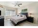 Tranquil bedroom features a tray ceiling, large windows, and an elegant ceiling fan at 1153 Village Cir, Erie, CO 80516