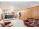 Basement with carpeted floors, wood paneling, and potential bar area at 8244 Clemson Ln, Westminster, CO 80031
