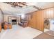 Basement with wood paneling, carpeted floors, and a vintage entertainment center at 8244 Clemson Ln, Westminster, CO 80031