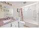 Bright bathroom with granite countertop and floral shower curtain at 8244 Clemson Ln, Westminster, CO 80031