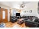 Inviting living room with hardwood floors, comfortable leather seating, and a bright window creating a cozy atmosphere at 8244 Clemson Ln, Westminster, CO 80031