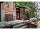 Charming brick building with a beautiful door and a comfortable bench at 3033 Blake St # 109, Denver, CO 80205
