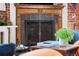 Close-up of fireplace with decorative screen, wooden mantel, and brick accents at 3033 Blake St # 109, Denver, CO 80205