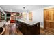 Bright open kitchen with stainless steel appliances, a large island, and rustic wood accents at 3033 Blake St # 109, Denver, CO 80205
