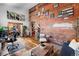 Open-concept living area with exposed brick, hardwood floors, and stylish decor at 3033 Blake St # 109, Denver, CO 80205