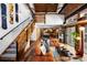 Spacious living room featuring exposed wood beams, an open staircase, and comfortable seating at 3033 Blake St # 109, Denver, CO 80205