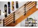 Close-up of the wooden staircase, snowboard decor, and a shelf with plants and decorations at 3033 Blake St # 109, Denver, CO 80205