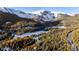 Aerial view of a snowy mountain community near a frozen lake at 381 Lake Rd, Idaho Springs, CO 80452