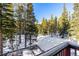 Spacious backyard with a hot tub and snowy landscape at 381 Lake Rd, Idaho Springs, CO 80452