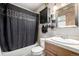 Bathroom with shower/tub combo, wood vanity, and dark curtain at 381 Lake Rd, Idaho Springs, CO 80452