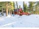 A-frame cabin exterior with deck and snowy landscape at 381 Lake Rd, Idaho Springs, CO 80452