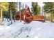 A-frame cabin with a large deck and hot tub, snowy setting at 381 Lake Rd, Idaho Springs, CO 80452