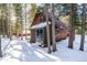 Cabin exterior with snowy ground and trees at 381 Lake Rd, Idaho Springs, CO 80452