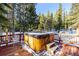 Hot tub on a deck overlooking snowy woods at 381 Lake Rd, Idaho Springs, CO 80452